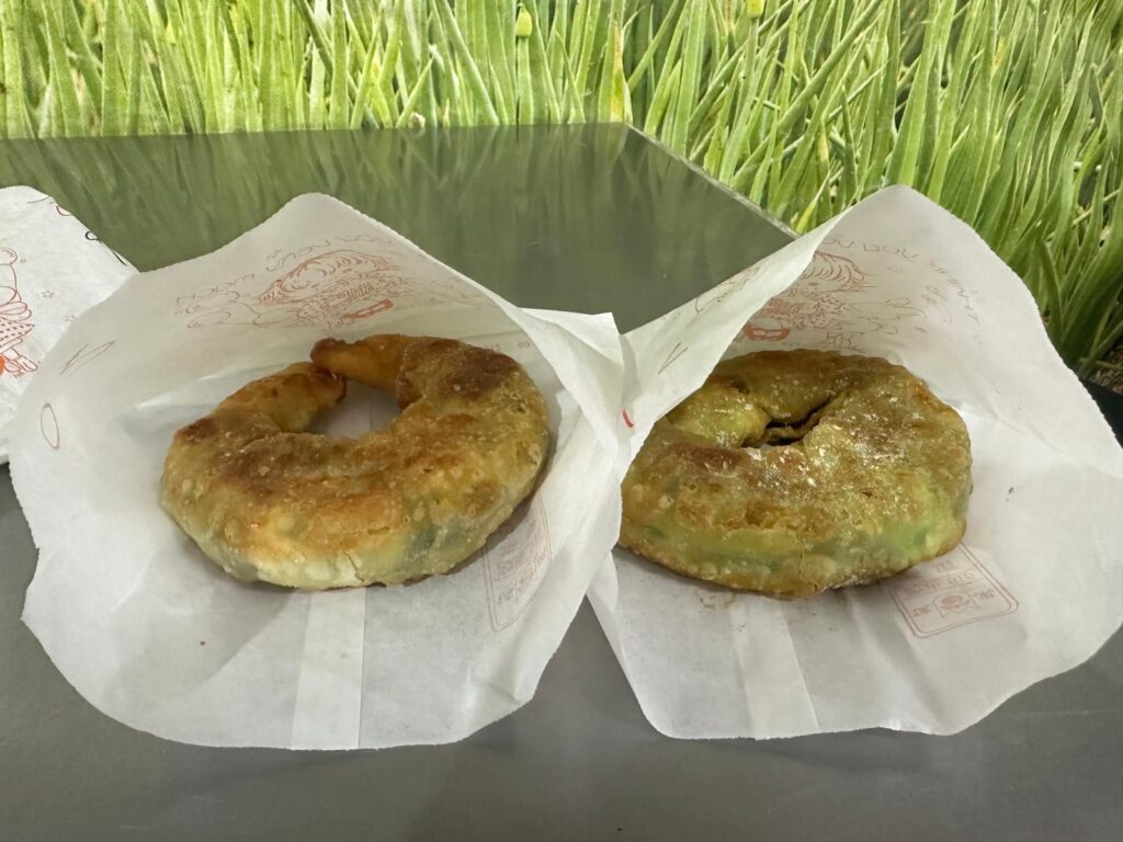 two Scallion Pancake on paper on a table