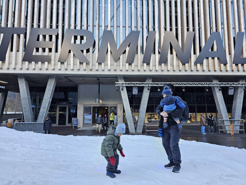 The boys playing with snow at the Entrance of Grindelwald Terminal