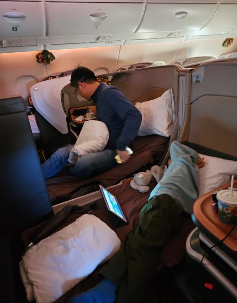 Hengboi totally enjoying his additional business class space and the special attention from the crew